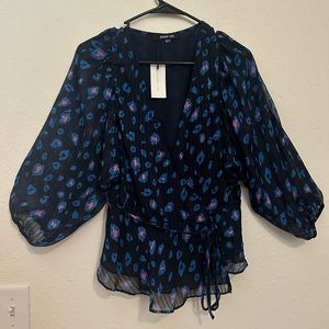 Button closure, tie detail, sheer arms